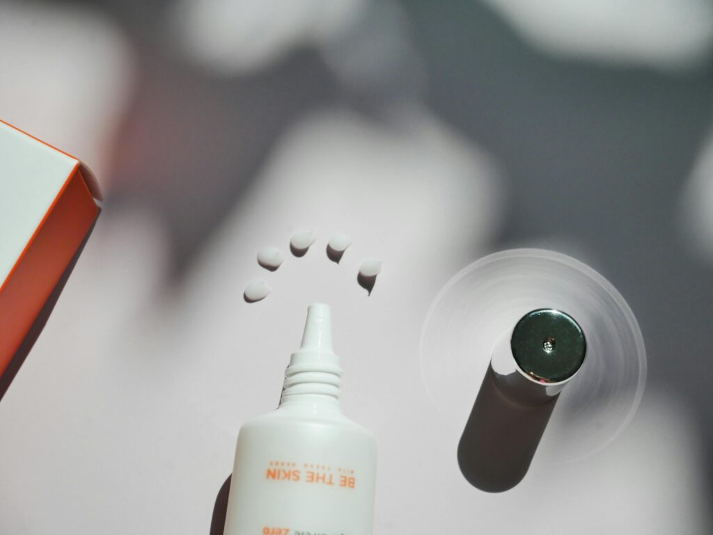 Creative still life of cosmetic products with dynamic shadows and textures.
