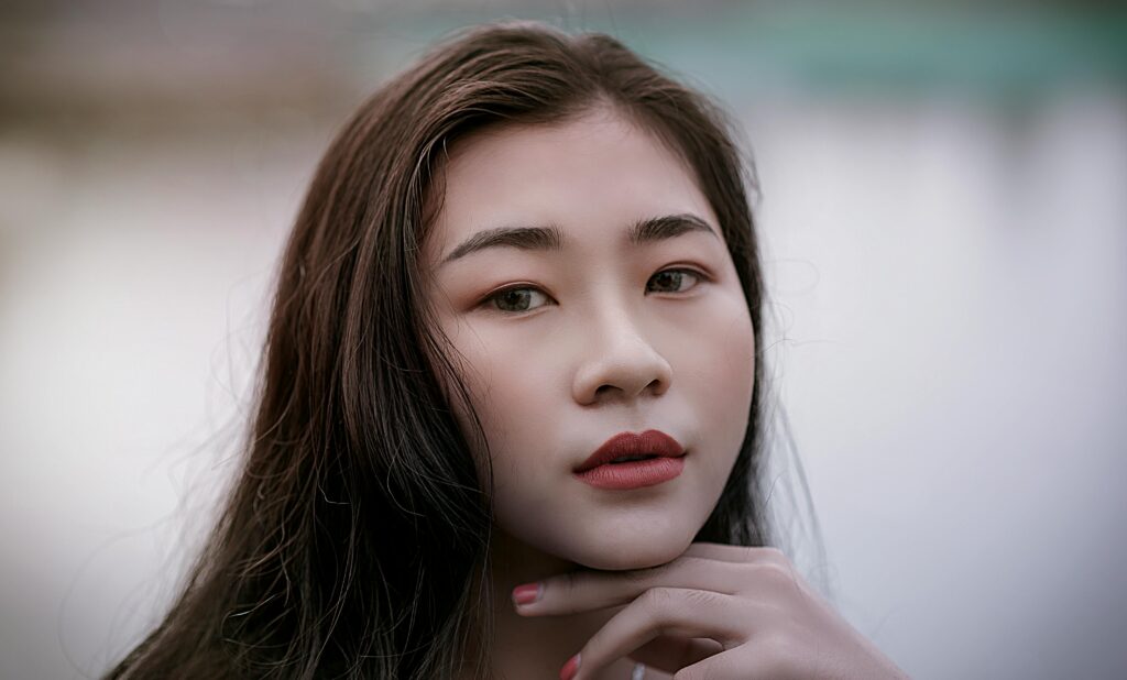 Close-up portrait of a stylish woman with elegant makeup and poise.